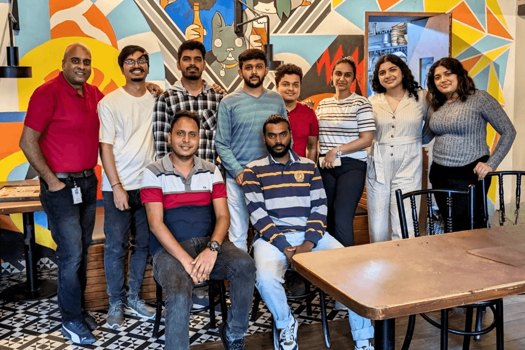 Simplileap team in front of a colorful mural