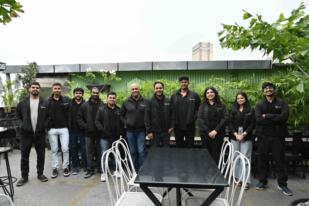 Simplileap team on an outdoor terrace in matching branded jackets